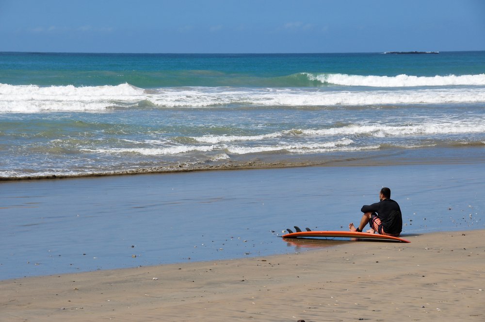 Surfer watching the ocean in Playa Negra, Costa Rica