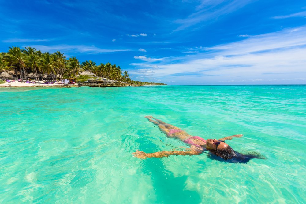 girls floating on turquoise water