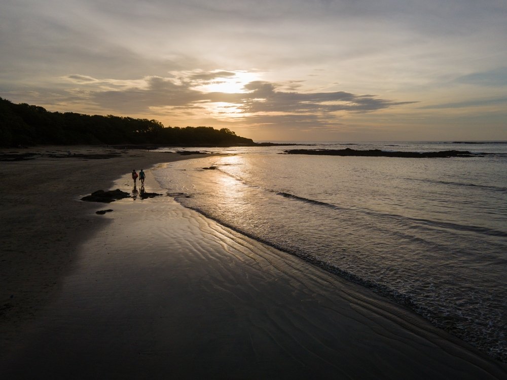 couple walking on Tamarindo Beach Costa Rica
