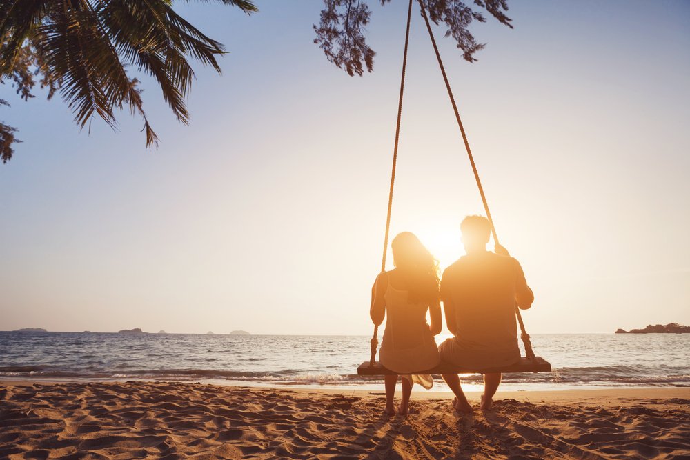 couple on a swing at sunset