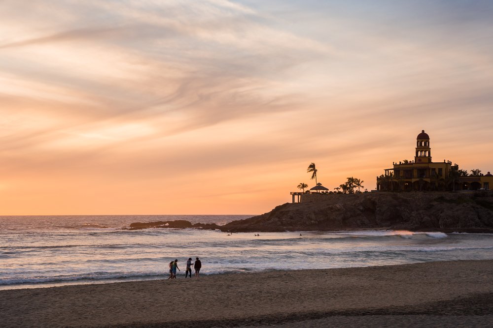people on the beach at sunset in Playa Todos Santos