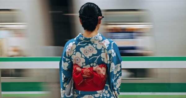 Japanese woman in front of moving train