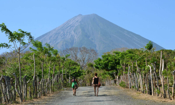 2 people walking towrd volcano in Nicaragua